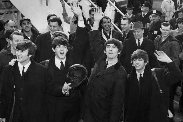 <p>Getty Images</p> The Beatles arrive at Kennedy Airport in Queens, New York