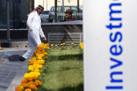 A Saudi trader walks near the investment department at the Arab National Bank in Riyadh, Saudi Arabia, Thursday, Dec. 12, 2019. Shares in Saudi Aramco gained on the second day of trading Thursday, propelling the oil and gas company to a more than $2 trillion valuation where it holds the title of the world's most valuable listed company. (AP Photo/Amr Nabil)