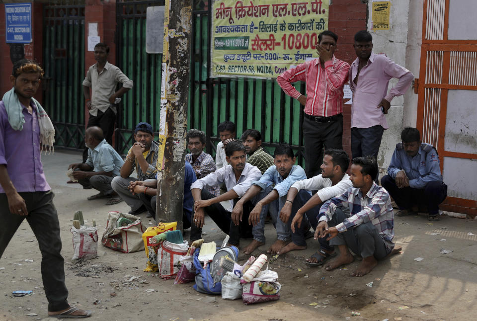 In this Sunday, Sept. 8, 2019, photo, Indian daily wage laborers and construction workers wait in anticipation to get hired on the outskirts of New Delhi, India. Confidence in the Indian economy is giving way to uncertainty as growth in the labor-intensive manufacturing sector has come to a near standstill, braking to 0.6% in the last quarter from 12.1% in the same period a year earlier. (AP Photo/Altaf Qadri)