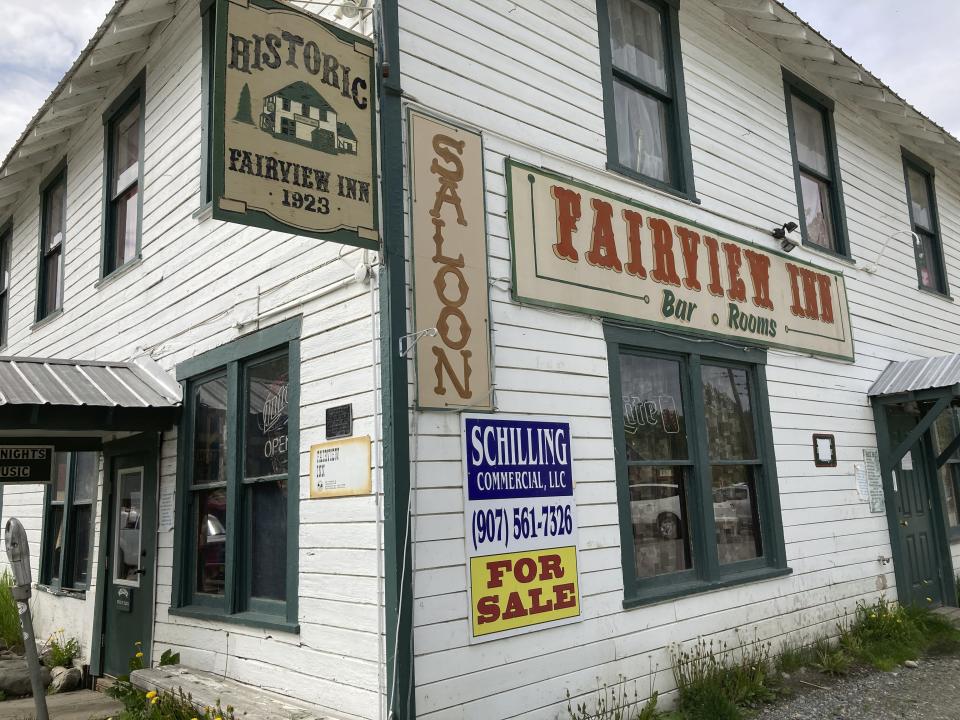 FILE - This June 2, 2020, file photo shows a For Sale sign at the Fairview Inn in Talkeetna, Alaska. Tourism is one of the main drivers of the Alaska economy, which means some businesses are suffering during the pandemic. Communities across Alaska are feeling the financial squeeze, from cruise ship ports where major lines have canceled summer sailings. Talkeetna, bills itself as the Gateway to Denali, where the ship passengers arrive on buses for inland excursions. Nearly half of the state's 2.2. million annual visitors usually arrive on those vessels. (AP Photo/Mark Thiessen, File)