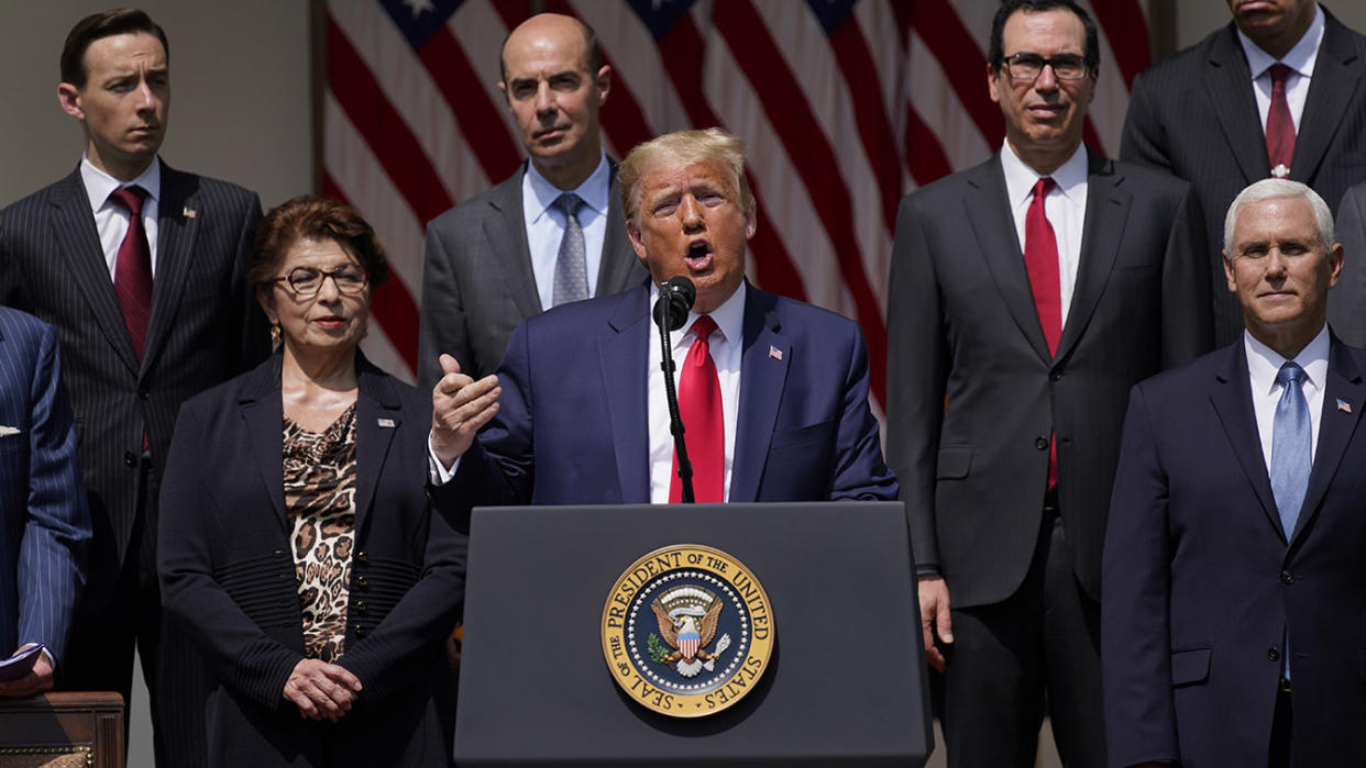 President Donald Trump speaks during a news conference in the Rose Garden of the White House, Friday, June 5, 2020, in Washington. Front row from left, Small Business Administration administrator Jovita Carranza, Trump, and Vice President Mike Pence. Back row from left, member of Council of Economic Advisers Tyler Goodspeed, Labor Secretary Eugene Scalia, Treasury Secretary Steven Mnuchin, and Chairman of the Council of Economic Advisers Tomas Philipson.(Evan Vucci/AP)