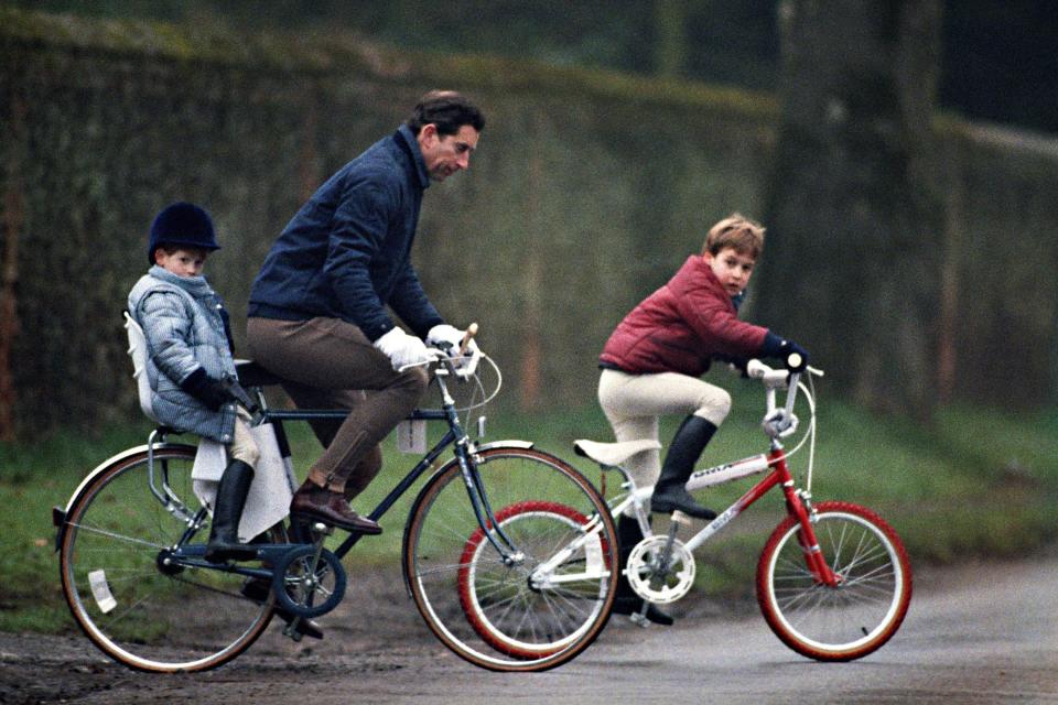 Prince Charles rides his bike with Prince William and Prince Harry.