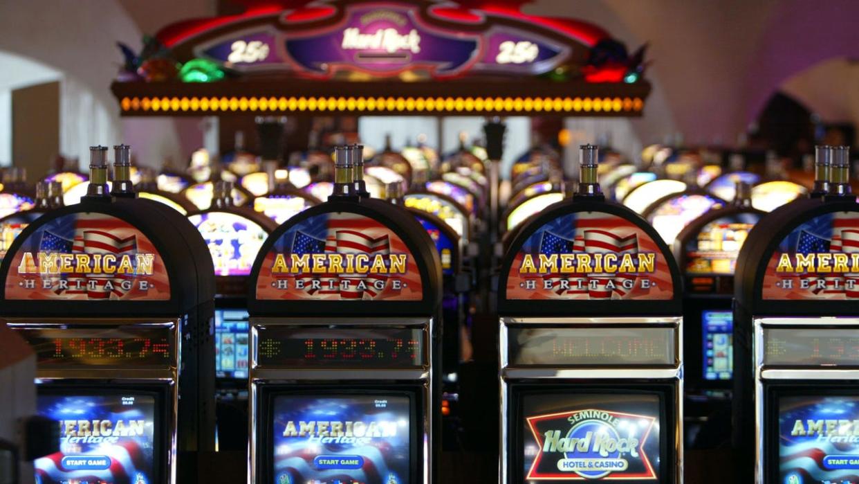 <div>HOLLYWOOD, FL - MAY 11: Slot machines wait for players May 11, 2004 during the grand opening for the Seminole Hard Rock Hotel and Casino in Hollywood, Florida. South Floridas Seminole Indian Tribe has opened the states biggest casino complex. The hotel has 500 rooms, 4,000 video gaming machines, poker tables and several restaurants. The public area has large ballrooms and a six-acre pool site with a 180-foot water slide. The Seminoles have shown big profits in past years by selling tax-free cigarettes and operating bingo halls, but the Hard Rock is its biggest venture thus far. (Photo by Joe Raedle/Getty Images)</div>