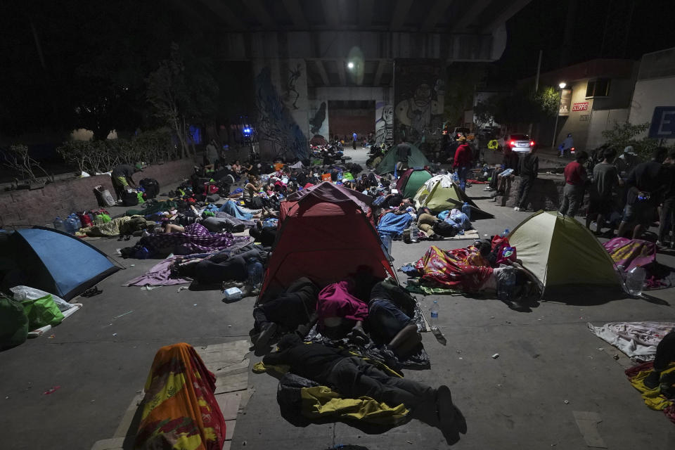 Migrants wait to hop a northbound freight train, in Irapuato, Mexico, Friday, Sept. 22, 2023. (AP Photo/Marco Ugarte)