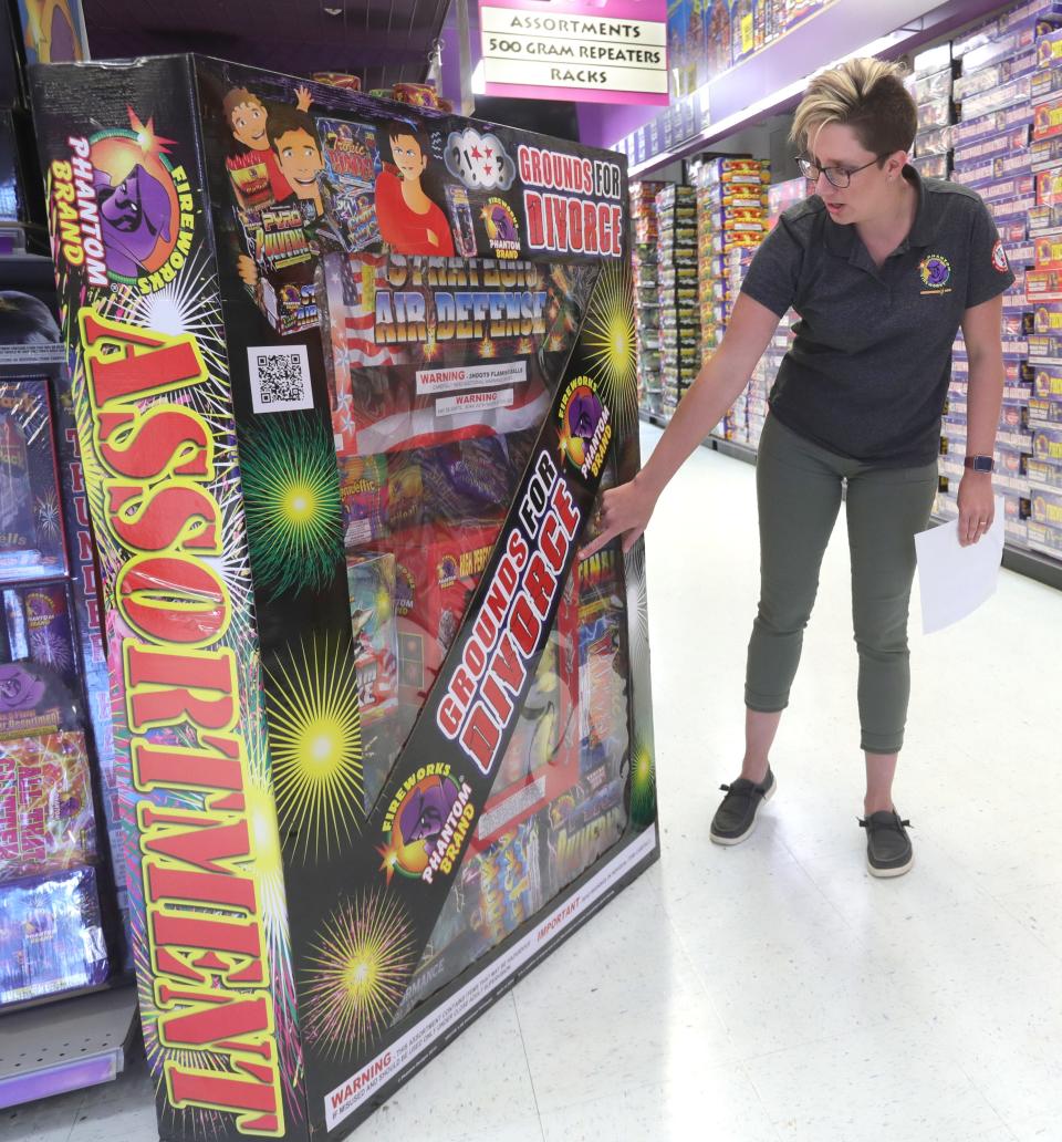 Phantom Fireworks manager Molly Whitehead shows the $2,000 Grounds for Divorce fireworks package that is one of their bestsellers.
