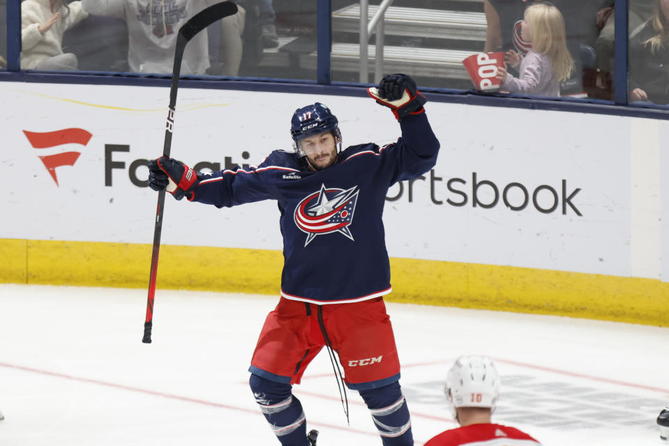 Columbus Blue Jackets forward Justin Danforth (17) celebrates after his goal in front of Calgary Flames forward Jonathan Huberdeau during the third period of an NHL hockey game in Columbus, Ohio, Friday, Oct. 20, 2023. (AP Photo/Paul Vernon)
