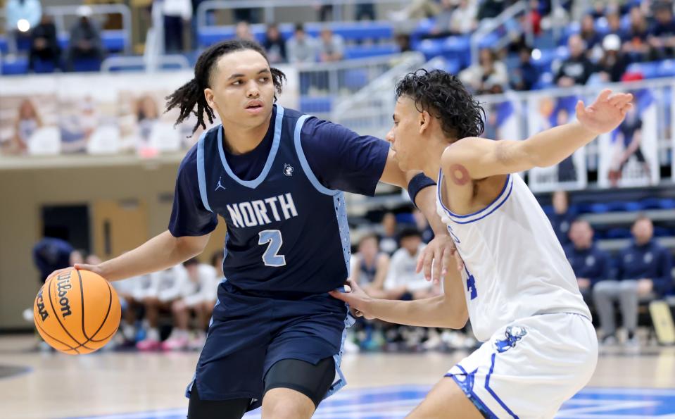 Edmond North's Chiante' Tramble looks to get by Deer Creek's Clyde Davis Jr. during a 59-52 win Friday night.