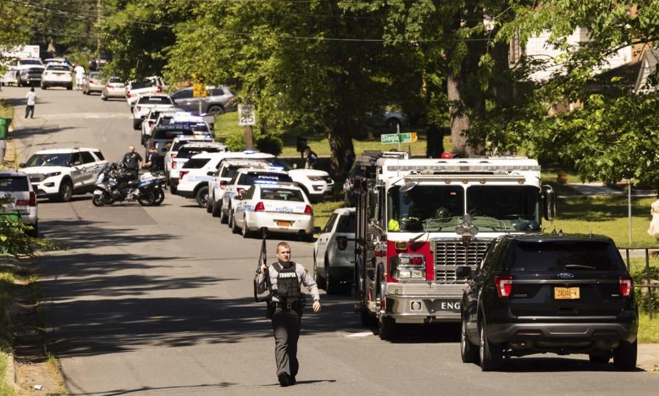 Multiple law enforcement vehicles respond in the neighborhood where several officers on a task force trying to serve a warrant were shot in Charlotte, N.C., Monday, April 29, 2024. (Melissa Melvin-Rodriguez/The Charlotte Observer via AP)