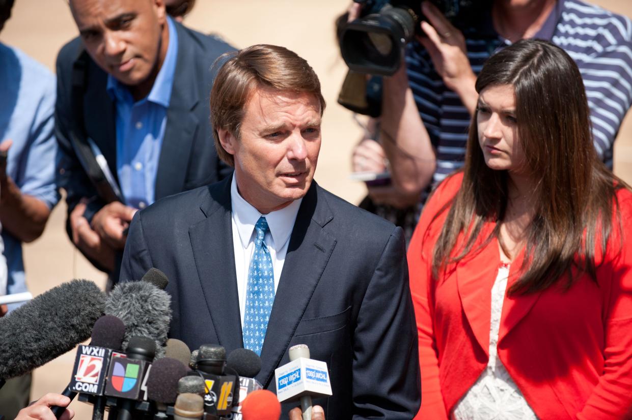 John Edwards (L) exits the Federal Courthouse with his daughter Cate Edwards and speaks to a crowd of reporters on June 3, 2011 in Winston Salem, North Carolina.