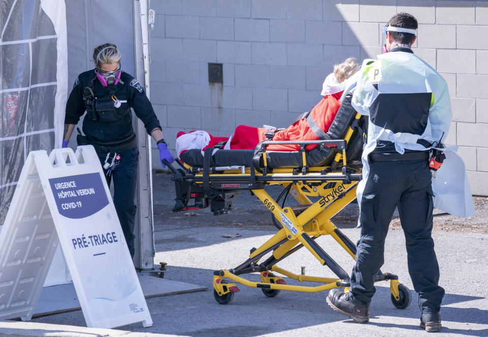 A patient is wheeled into the emergency unit of the Verdun Hospital in Montreal on Monday, April 6, 2020. Prime Minister Justin Trudeau says he’s confident Canada will still be able to import N95 protective masks form the U.S. despite an export ban and says he will talk to U.S. President Donald Trump in the coming days. (Paul Chiasson/The Canadian Press via AP)