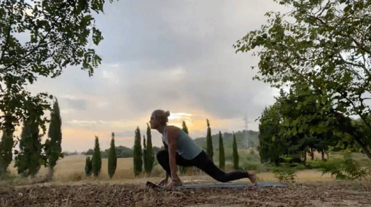 Woman practicing an early morning yoga routine in a lunge