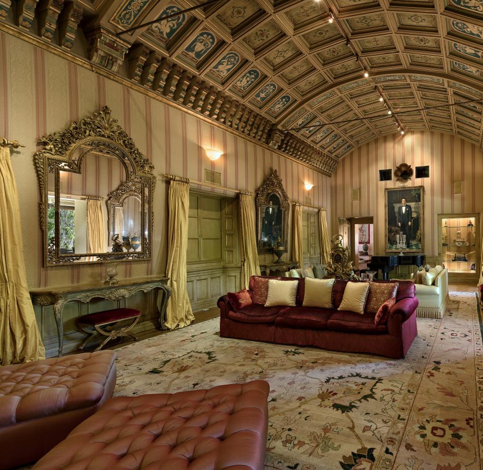 The formal living room features 22-foot-high hand-painted arched ceilings.