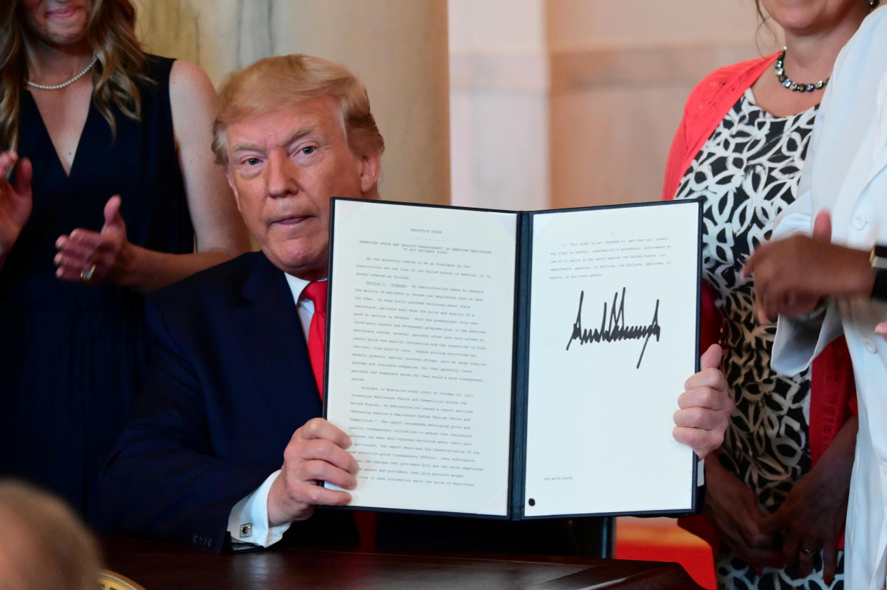 U.S. President Donald Trump signs an executive order aimed at requiring hospitals to be more transparent about prices before charging patients for healthcare services, at the White House in Washington, U.S. June 24, 2019. REUTERS/Erin Scott