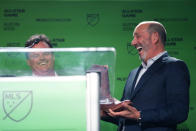 Majority Owner and Chief Executive Officer of Austin FC Anthony Precourt, left, shares a laugh with Major League Soccer Commissioner Don Garber, right, after presenting Garber a pair of cowboy boots, Wednesday, May 15, 2024, in Austin, Texas. Garber announced that Austin FC will host the 2025 MLS All-Star soccer game. (AP Photo/Eric Gay)