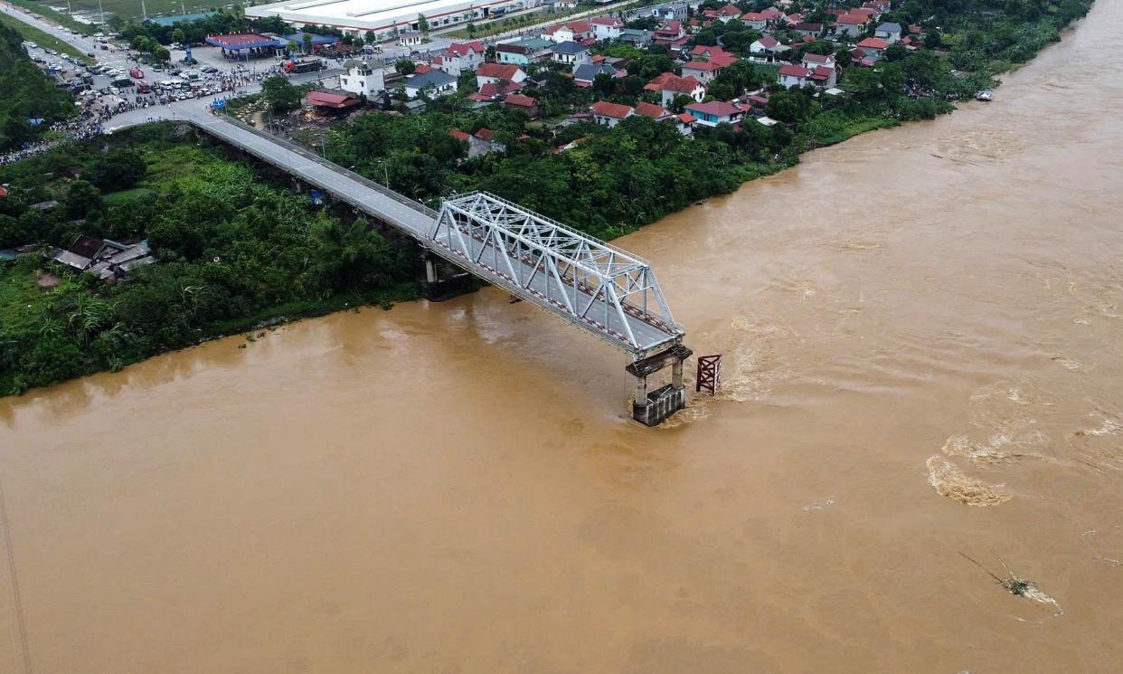 <span>An aerial view of the partially collapsed Phong Chau bridge into Red River, in Phu Tho province, northern Vietnam.</span><span>Photograph: Ta Toan/Vietnam News Agency handout/EPA</span>