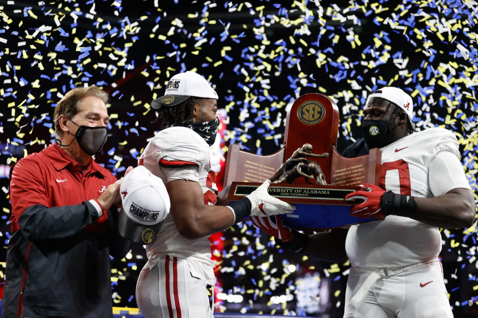 ATLANTA, GA - DECEMBER 19: Head Coach Nick Saban, Alex Leatherwood #70, and Najee Harris #22 of the Alabama Crimson Tide holding the SEC Championship trophy after the victory over the Florida Gators at Mercedes-Benz Stadium on December 19, 2020 in Atlanta, Georgia. (Photo by UA Athletics/Collegiate Images/Getty Images)