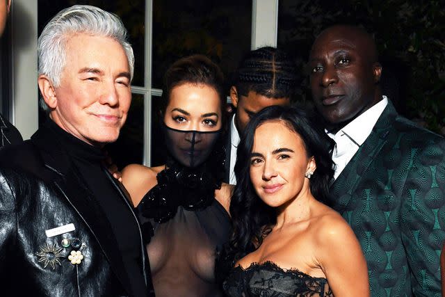 <p>Dave Benett/Getty Images</p> Baz Luhrmann, Rita Ora, guest and Sir Ozwald Boateng attend British Vogue's 2023 Forces for Change party
