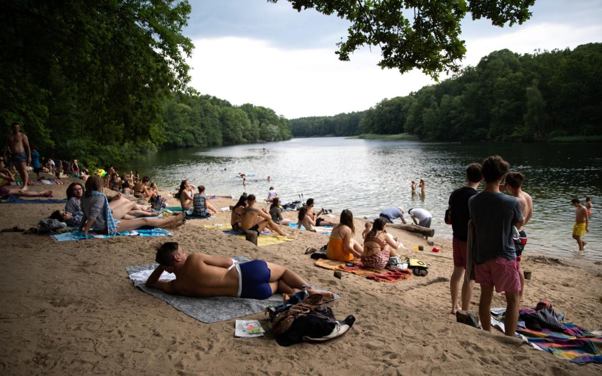 People visit the Krumme Lanke lakeside in Berlin, Germany, 26 June 2020 - HAYOUNG JEON/EPA-EFE/Shutterstock
