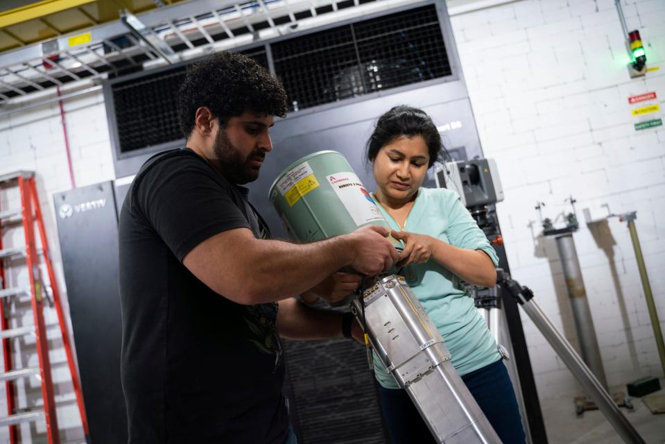 Mejdi Mogannam, a Ph.D. student, left, and Rebeka Lubna, a post-doctoral researcher, work with a clover detector at the Facility for Rare Isotope Beams (FRIB) at Michigan State University in East Lansing on Tuesday, Aug. 1, 2023.