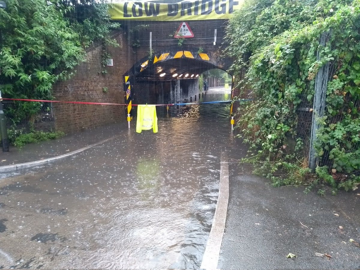 A flooded road in south London after heavy rainfall (@DanHolden85/PA) (PA Media)