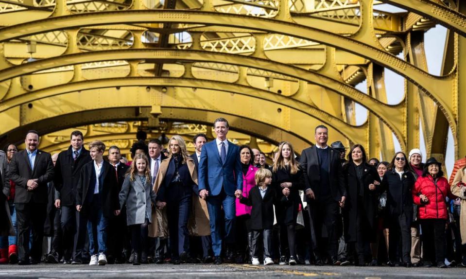 California Gov. Gavin Newsom participates in a march from the Tower Bridge with with his family and various dignitaries and community members on Friday, January 6, 2023.