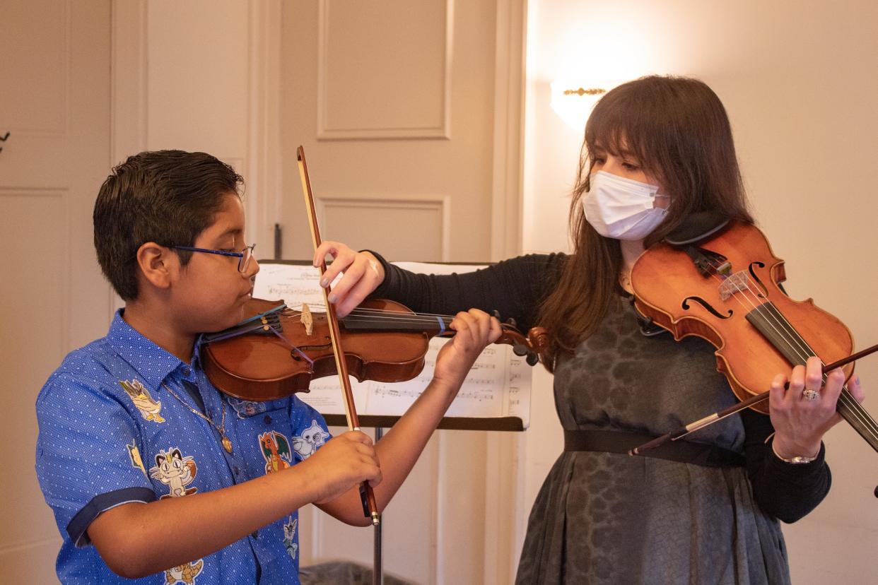 Talia Pavia, chair of the Wisconsin Conservatory of Music's String Department instructs Adrian Jesus Marin Rivera during a violin lesson. He and his sister, Citlalli, 12, have been learning to play the violin at the conservatory since 2018. Their younger brother Cesar Gabriel, 7, started three weeks ago.