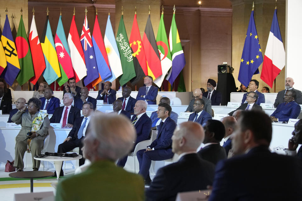 French President Emmanuel Macron, center, and other leaders attend the closing session of the New Global Financial Pact Summit, Friday, June 23, 2023 in Paris. The aim of the two-day climate and finance summit was to set up concrete measures to help poor and developing countries whose predicaments have been worsened by the devastating effects of the COVID-19 pandemic and the war in Ukraine better tackle poverty and climate change. (AP Photo/Lewis Joly, Pool)