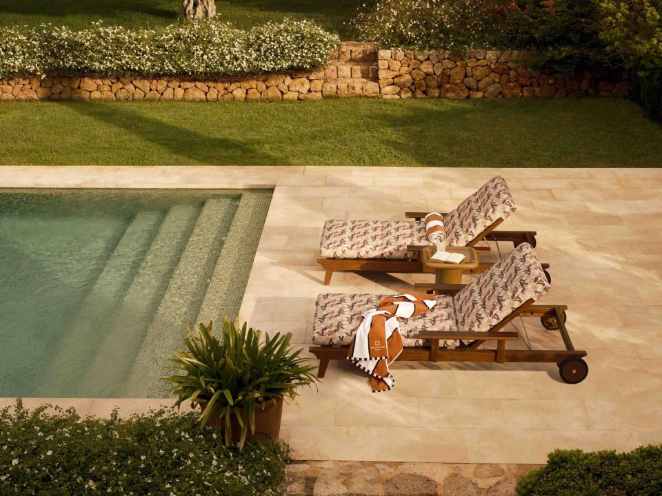 two sun loungers next to a pool