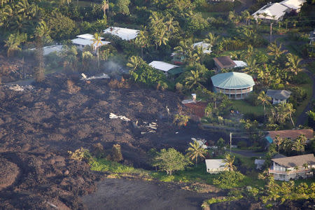 Lava destroys homes in the Kapoho area, east of Pahoa, during ongoing eruptions of the Kilauea Volcano in Hawaii, U.S., June 5, 2018. REUTERS/Terray Sylvester