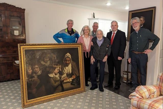 <p>FBI</p> The Wood family posed with the newly-returned John Opie painting, "The Schoolmistress," January 11, 2024.