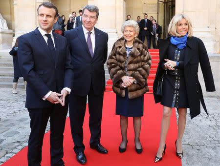 France's President Emmanuel Macron and his wife Brigitte Macron are welcomed by academicians Xavier Darcos and Helene Carrere d'Encausse as they arrive at the French Institute, where Macron will unveil his strategy to promote French language as part of the International Francophonie Day, before members of the French Academy and other guests, in Paris, France, March 20, 2018. Ludovic Marin/Pool via REUTERS