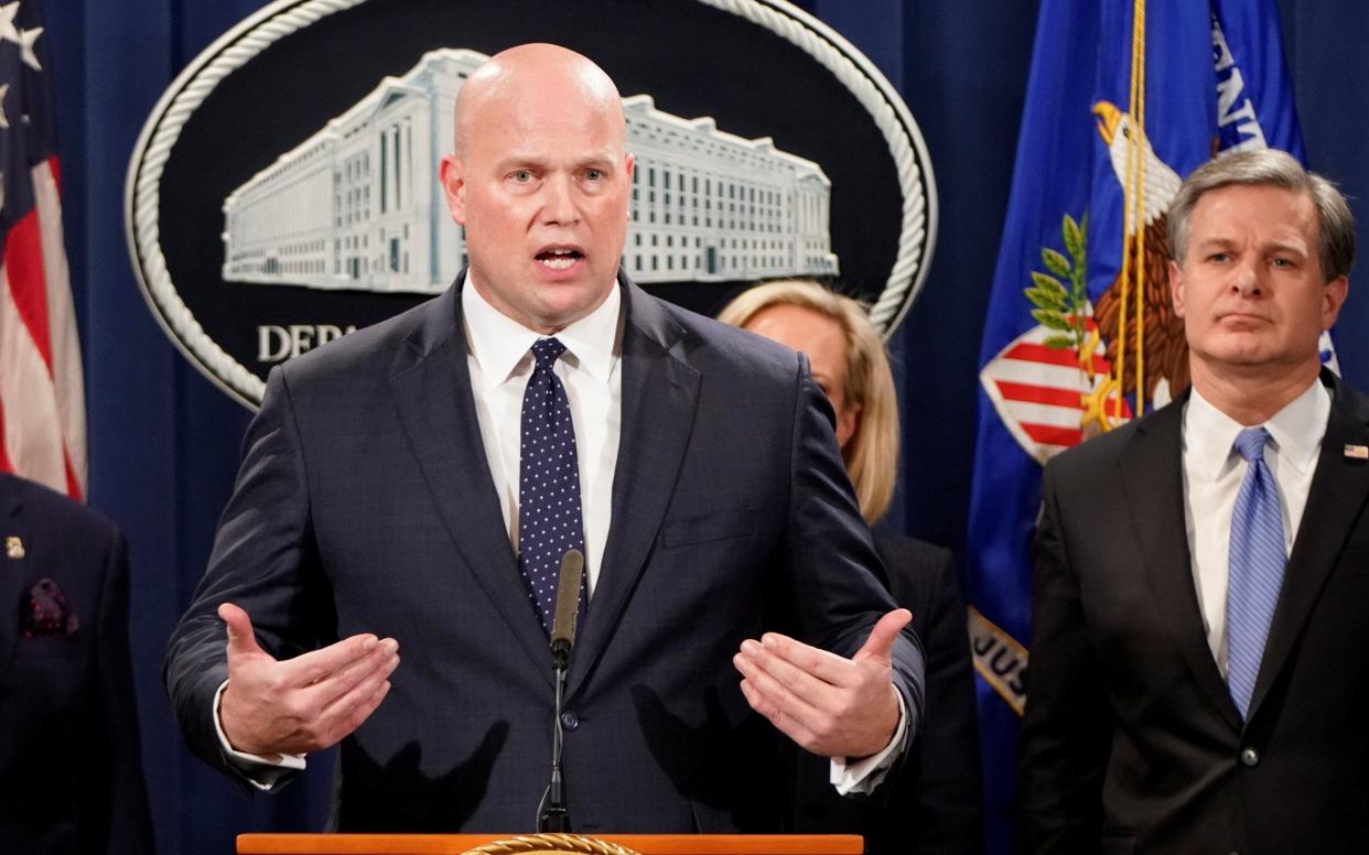 Acting attorney general Matthew Whitaker announcing the charges - REUTERS