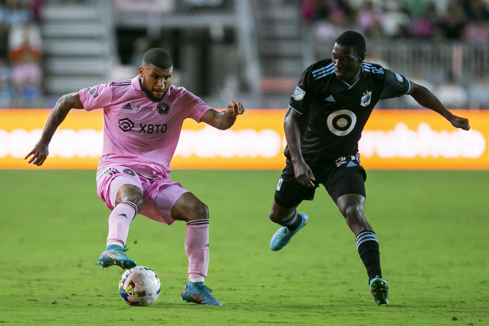 Inter Miami CF defender DeAndre Yedlin (2) fights for possession against Minnesota United forward Bongokuhle Hlongwane (21) during the first half of an MLS soccer match Saturday, June 25, 2022, in Fort Lauderdale, Fla. (Matias J. Ocner(Matias J. Ocner/Miami Herald via AP)