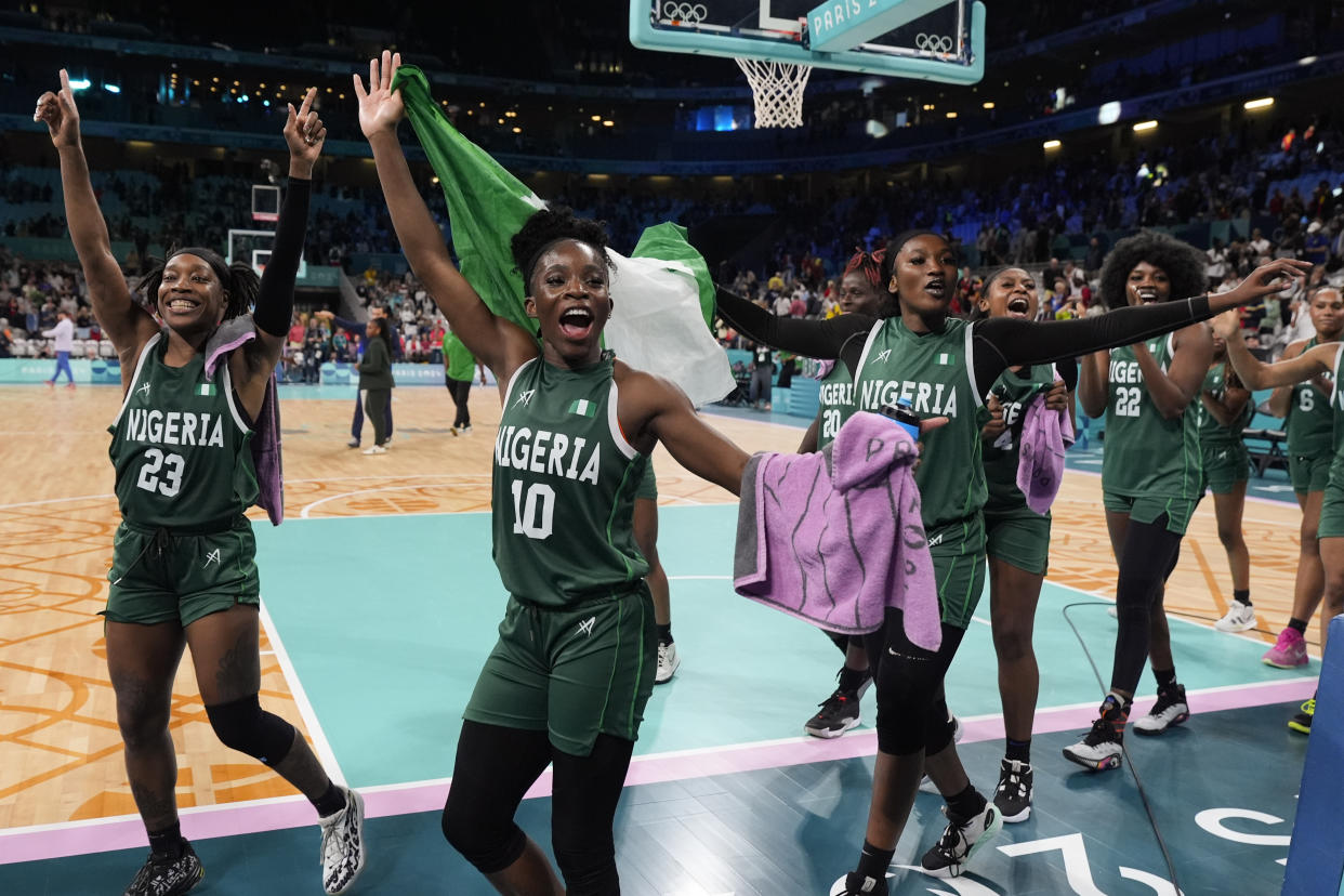 From left: Ezinne Kalu, Promise Amukamara and Adebola Adeyeye, of Nigeria, celebrate after defeating Canada in a women's basketball game at the Summer Olympics on Sunday.