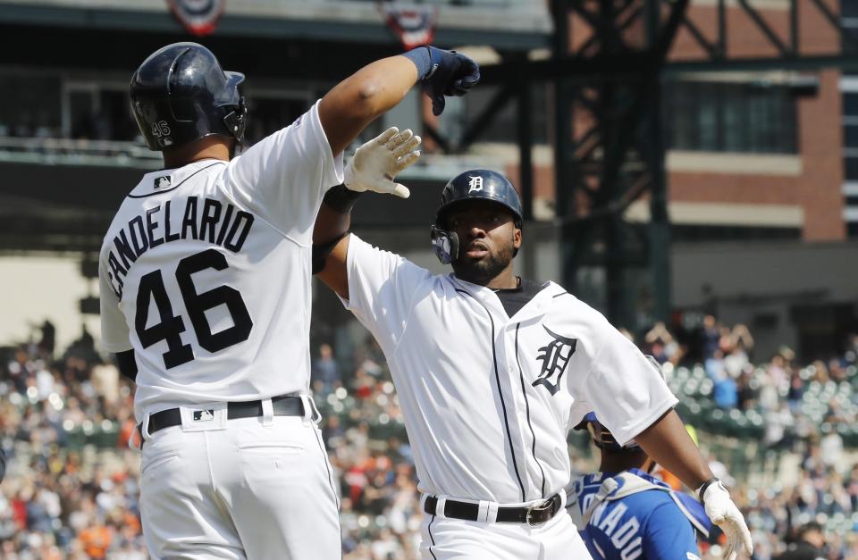 Detroit Tigers' Christin Stewart is congratulated by Jeimer Candelario after hitting a grand slam during the seventh inning of a baseball game against the Kansas City Royals, Saturday, April 6, 2019, in Detroit. (AP Photo/Carlos Osorio)