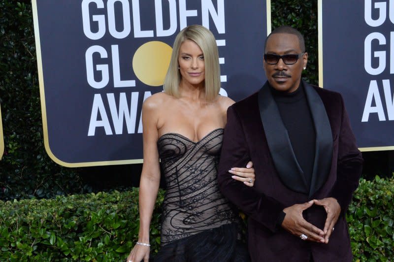 Eddie Murphy (R) and Paige Butcher attend the Golden Globe Awards in 2020. File Photo by Jim Ruymen/UPI