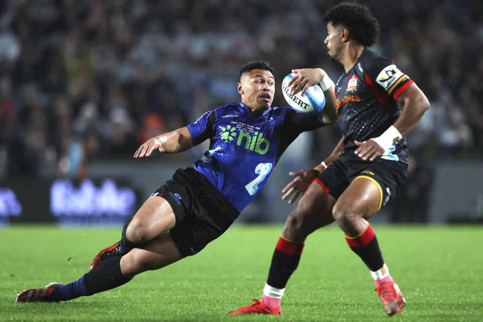 Blues winger Caleb Clarke runs at the defense during the Super Rugby final between the Chiefs and the Blues in Auckland, New Zealand, Saturday, June 22, 2024. (Brett Phibbs/Photosport via AP)