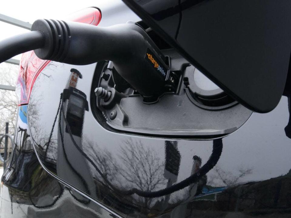 An electric car recharges at a designated station. Supply chain challenges, high gas prices and Russia&#39;s invasion of Ukraine are all contributing to electric vehicle shortages and long delivery wait times seen in many parts of Canada and the world. (Sean Kilpatrick/The Canadian Press - image credit)