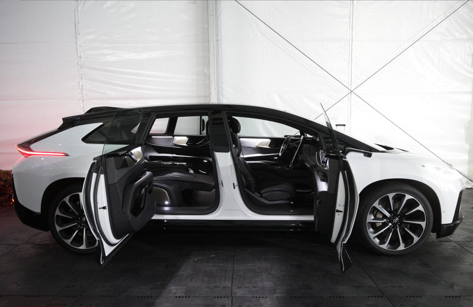 The Faraday Future FF 91, a long, low, and luxurious four-door EV is shown during the "Faraday's Future: Transforming The Road of Future Mobility," panel discussion at the AutoMobility LA auto show at the Los Angeles Convention Center in Los Angeles Tuesday, Nov. 19, 2019. (AP Photo/Damian Dovarganes)