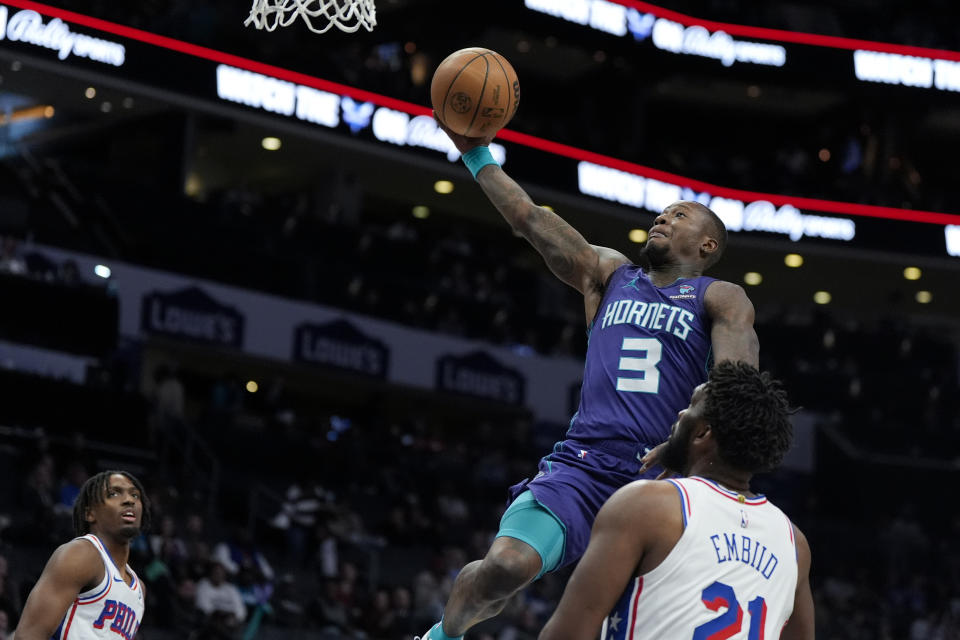 Charlotte Hornets guard Terry Rozier shoots over Philadelphia 76ers center Joel Embiid during the first half of an NBA basketball game on Saturday, Jan. 20, 2024, in Charlotte, N.C. (AP Photo/Chris Carlson)