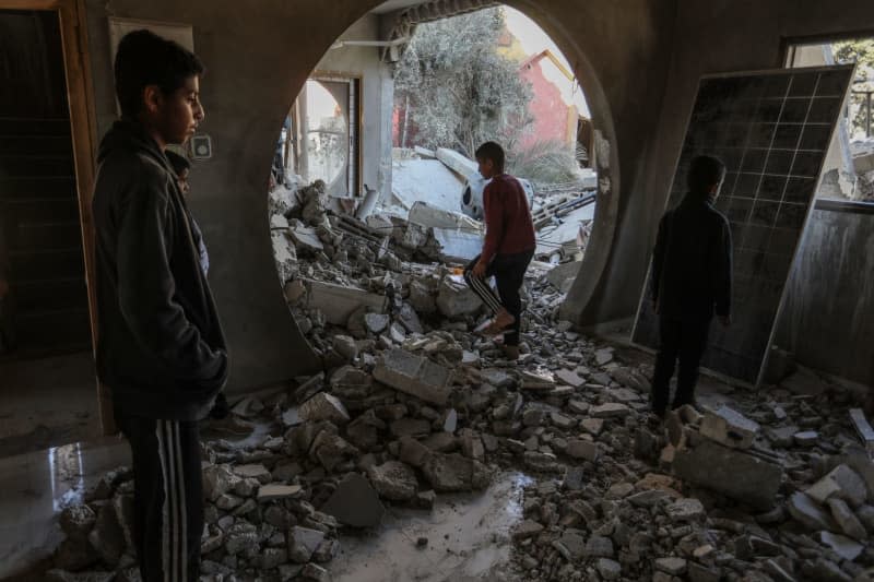 Palestinian children inspect the destruction following an Israeli airstrike on a house belonging to the Al-Faqawi family. Abed Rahim Khatib/dpa