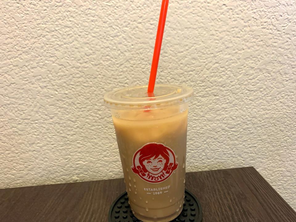 Wendy's iced coffee on wooden table