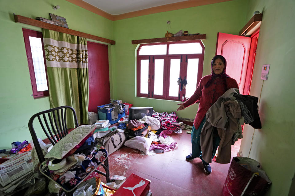 Prabha Sati packs her belongings before moving out from her home in Joshimath, India's Himalayan mountain state of Uttarakhand, Jan. 19, 2023. For months, residents in Joshimath, a holy town burrowed high up in India's Himalayan mountains, have seen their homes slowly sink. They pleaded for help, but it never arrived. In January however, their town made national headlines. Big, deep cracks had emerged in over 860 homes, making them unlivable. (AP Photo/Rajesh Kumar Singh)