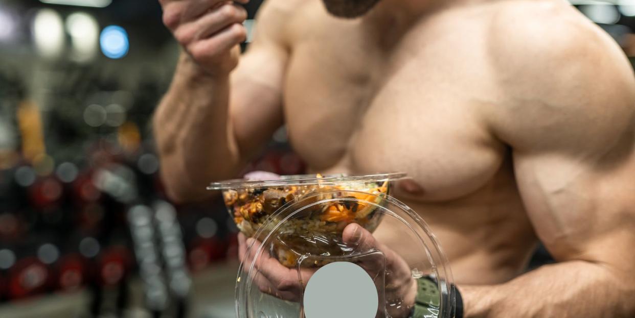 powerful athletic man with great physique eating a healthy salad mockup your brand