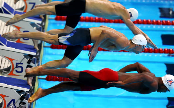 Michael Phelps (C) dives of off the starting block as he competes in preliminary heat 13 of the Men's 100 m Butterfly during Day Six of the 2012 U.S. Olympic Swimming Team Trials at CenturyLink Center on June 30, 2012 in Omaha, Nebraska. (Photo by Al Bello/Getty Images)