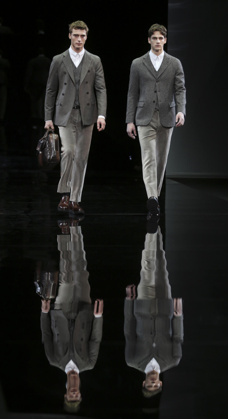 Models wear creations for Giorgio Armani men's Fall-Winter 2014 collection, part of the Milan Fashion Week, unveiled in Milan, Italy, Tuesday, Jan.14, 2014. (AP Photo/Luca Bruno)