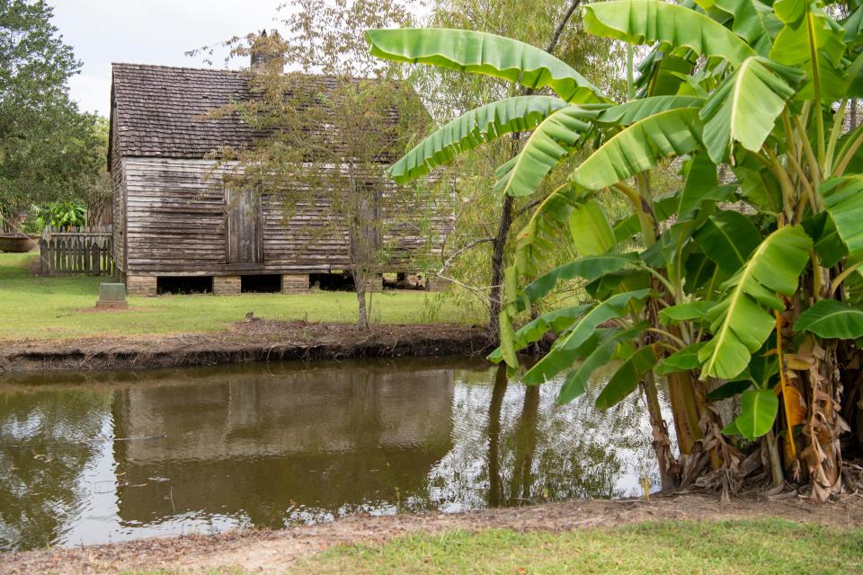 One of seven slave dwellings sits beside a drainage canal at the Whitney Plantation Museum in Wallace, La. The plantation originally had 22 such dwellings.