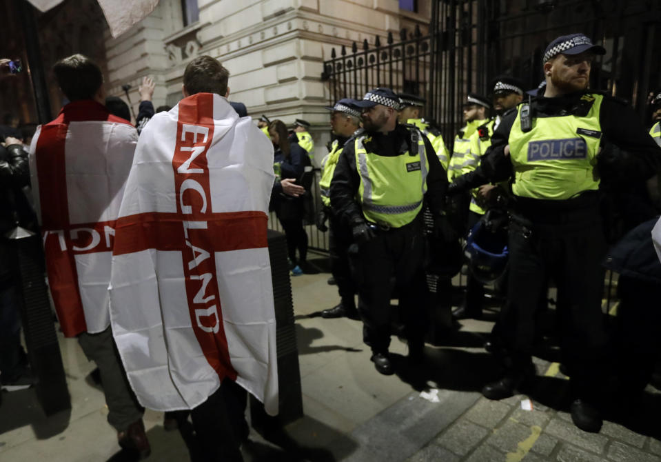 Pro-Brexit protesters stand near police after their rally in Westminster, London, Friday, March 29, 2019. Pro-Brexit demonstrators were gathering in central London on the day that Britain was originally scheduled to leave the European Union. British lawmakers will vote Friday on what Prime Minister Theresa May's government described as the "last chance to vote for Brexit." (AP Photo/Kirsty Wigglesworth)