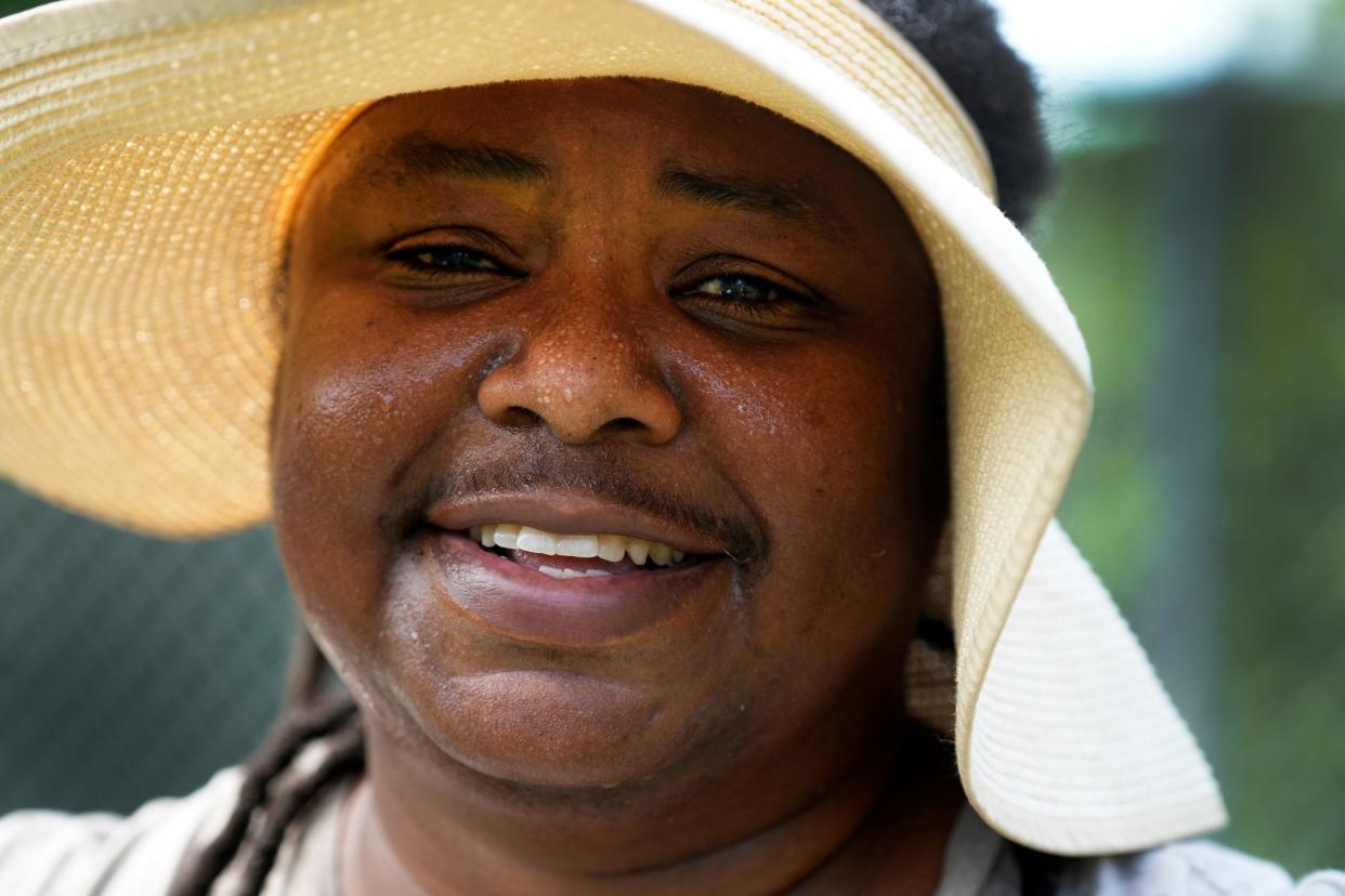 Tory Young finishes her work mid-morning at the West End Community Garden. A heat advisory was issued Monday as the heat index creeped into the triple digits.