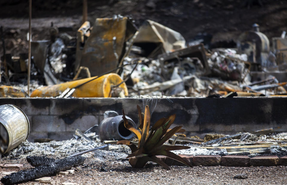 Debris from a house that was destroyed by the South Fork Fire are shown in the mountain village of Ruidoso, N.M., Saturday, June 22, 2024. Recent rains and cooler weather are helping more than 1,000 firefighters gain ground on two wildfires in southern New Mexico that have killed two people, destroyed hundreds of homes and forced thousands to flee. (AP Photo/Andres Leighton)